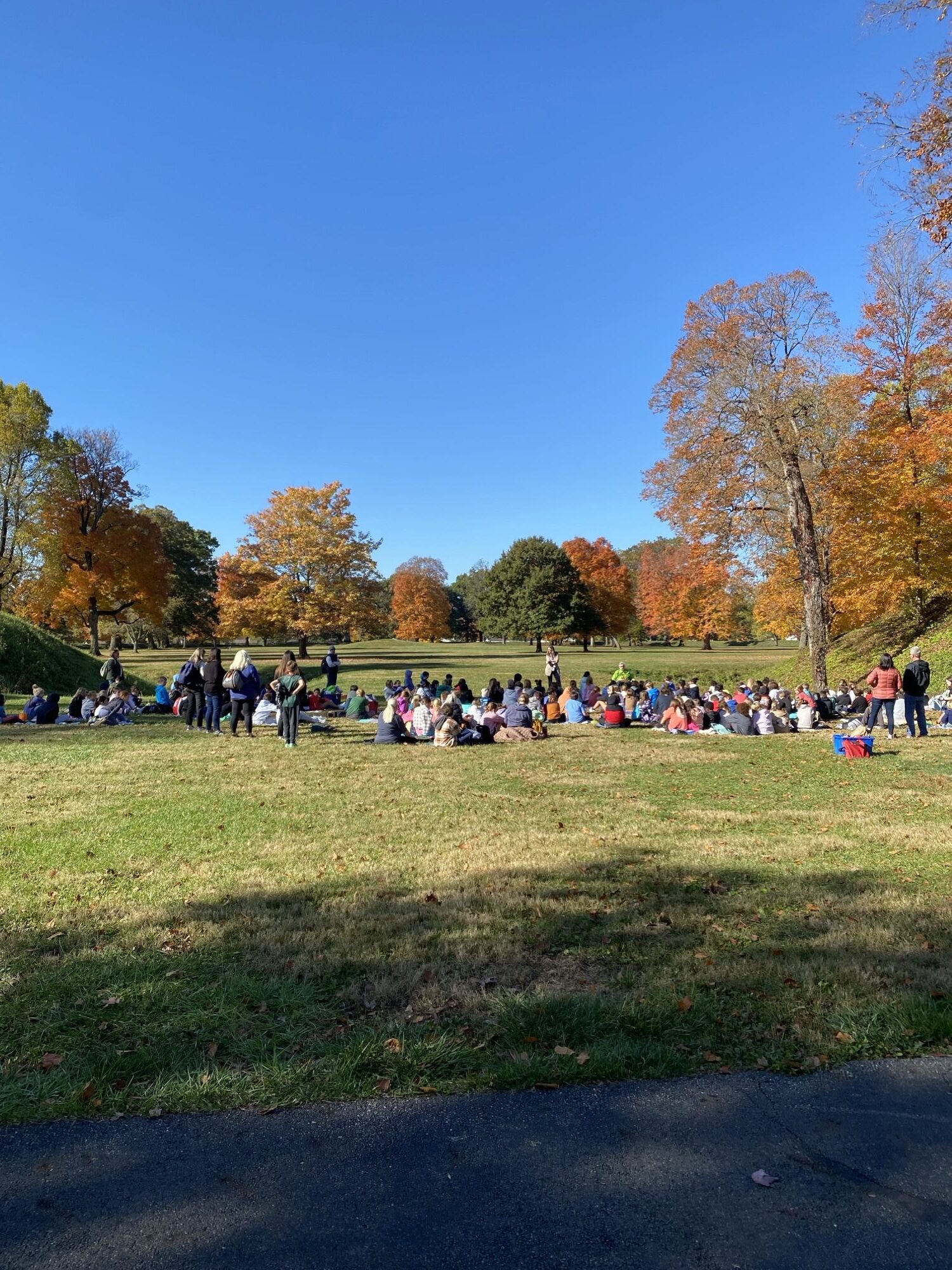 A large group of school children gathered at the entrance into the Great Circle Earthwork.