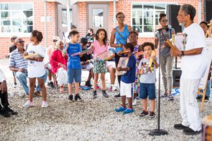Group of people participating on the Poindexter Village Drum Circle.