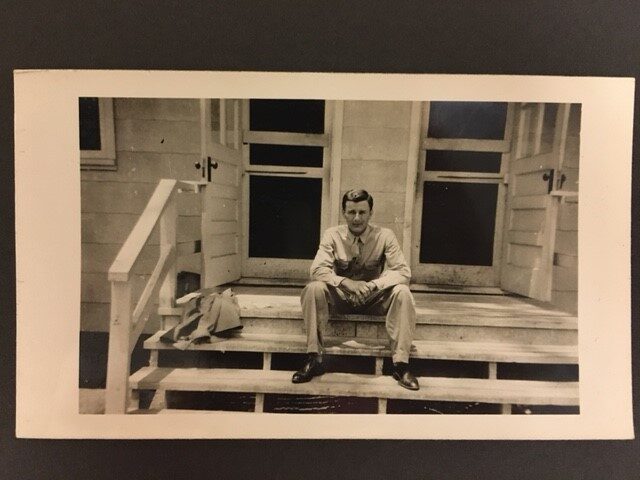 Man on porch at Bear Creek