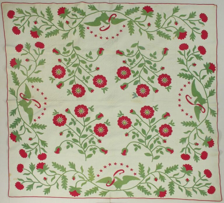 Red and green applique quilt in a star flower pattern