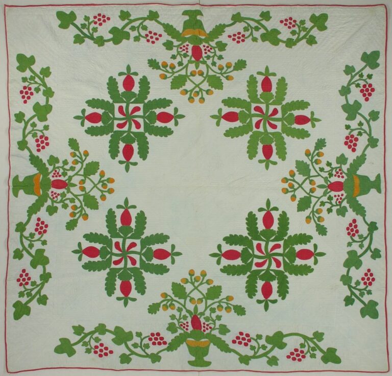 Red and green applique quilt in a pineapple swastika pattern