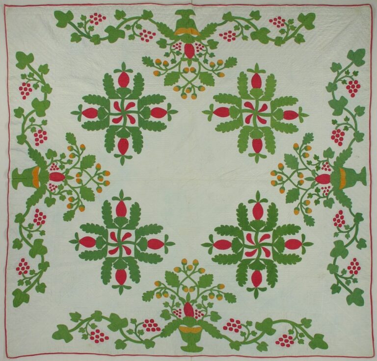 Red and green applique quilt in a pineapple swastika pattern