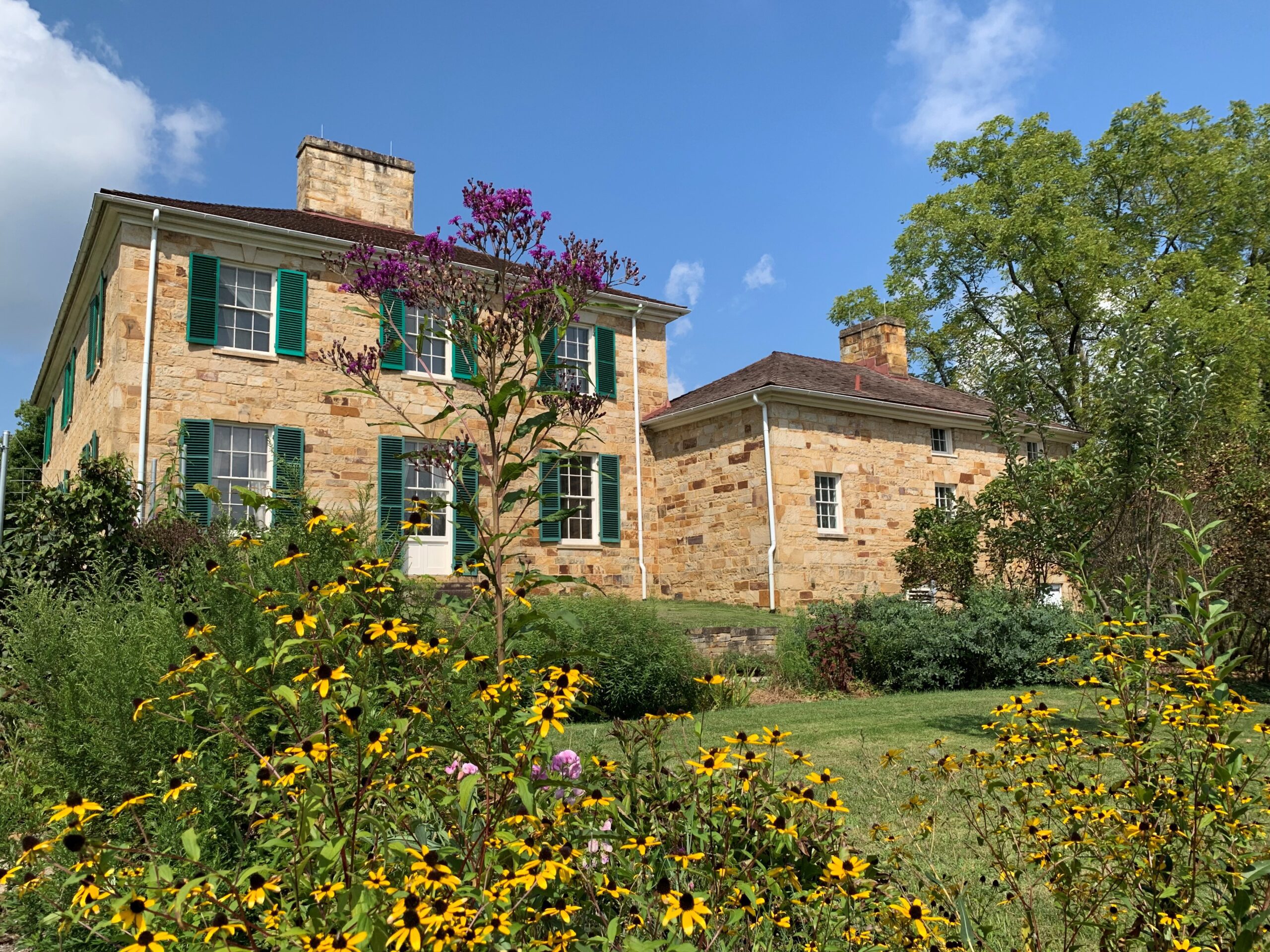 Outside of Adena Mansion showing the gardens and mansion