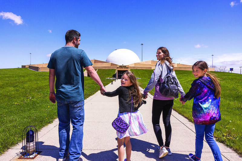 Family Walking to the Main Entrance of the Armstrong Air & Space Museum