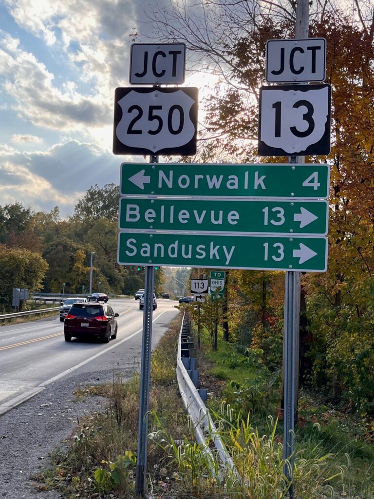 Outside image of the interstate sign that shows Rt 250 and Jct 13 with directional signage to Sandusky, Bellevue, and Norwalk.