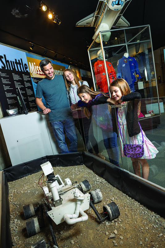 Visitors viewing an exhibit at the Armstrong Air & Space Museum