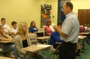 teacher in classroom with teenage students