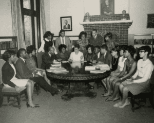 Yvonne Walker-Taylor sitting with Wilberforce University Students in the Wilberforce Carnegie Library. 