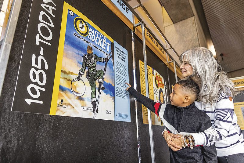 Child and Adult reading sign at the National Afro-American Museum and Cultural Center