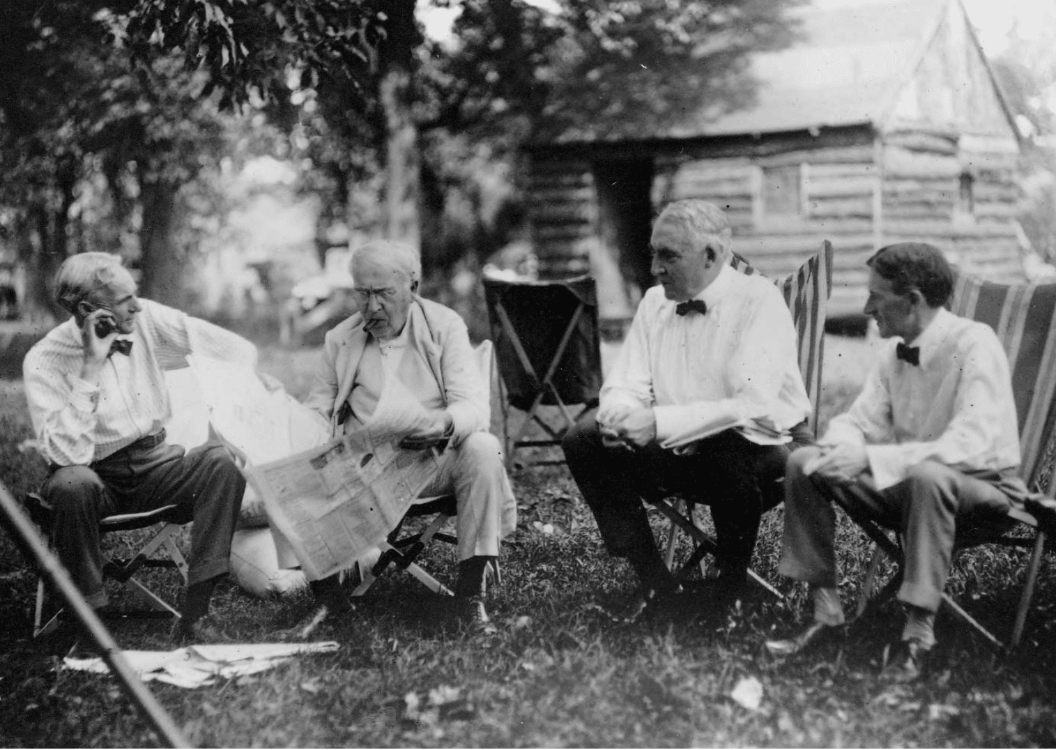 Henry Ford, Thomas Edison, Warren G. Harding and Harvey Firestone seated in camping chairs