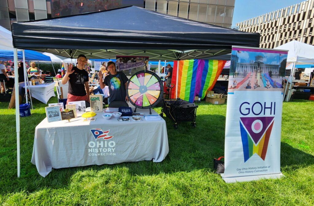 A photo of two OHC staff tabling for GOHI at Toledo Pride 2023.