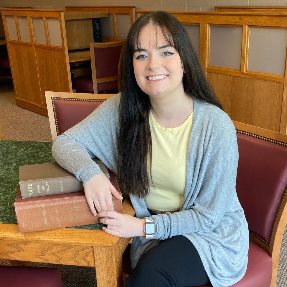 A woman sitting in a chair.