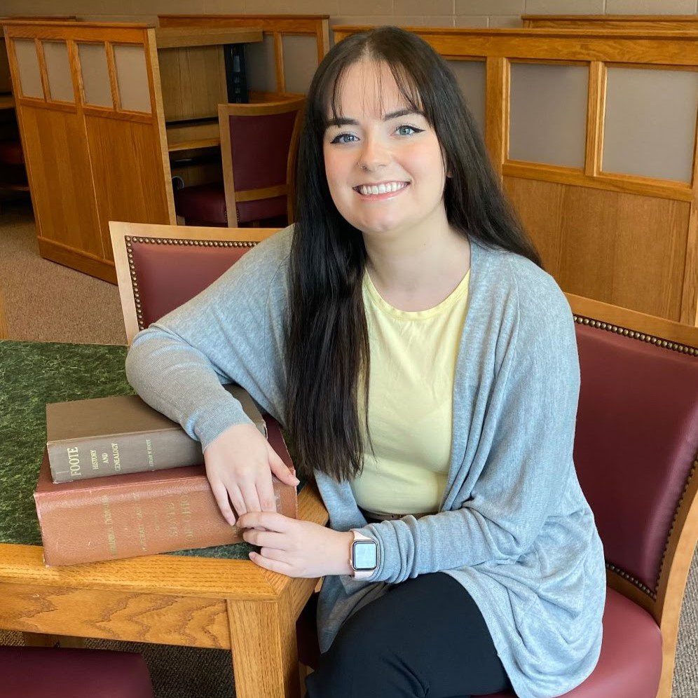 A woman sitting in a chair.