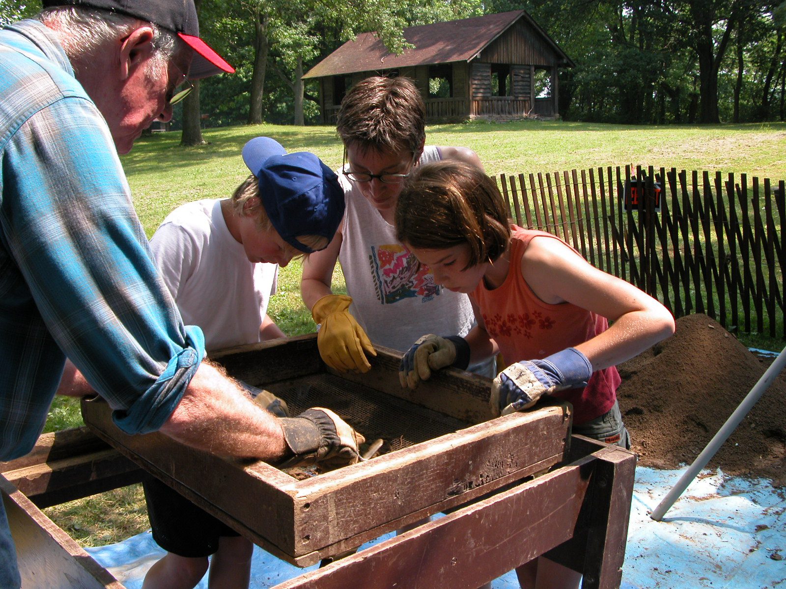 Volunteers screening dirt, looking for artifacts