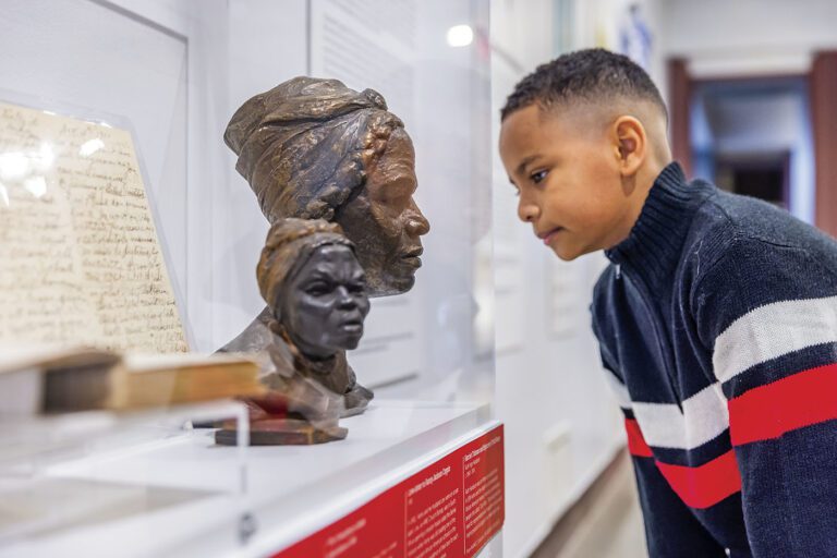 Image of an African American child viewing a sculpture at the National Afro-American Museum and Cultural Center