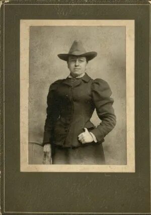 A photo of Ned Ross in the 1890s. Ned is wearing a heavy dress and a men's long-brim hat in the photo.