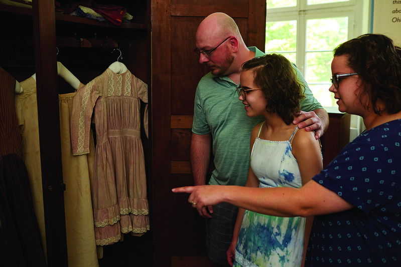 Image of family looking at clothing in Zoar Village