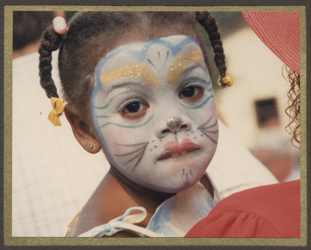 Young African American girl with face paint.