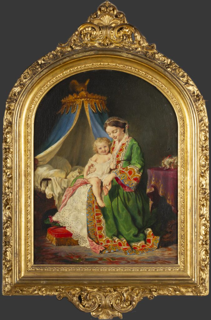 A woman in a green dressing gown plays with the toes of the young child sitting on her lap. An ornate canopied child's bed is visible in the background.