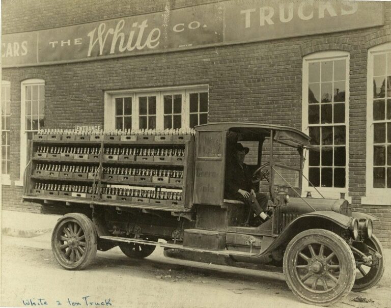 Black and white image of a White Motor Company truck parked in front of the White Motor Company factory 