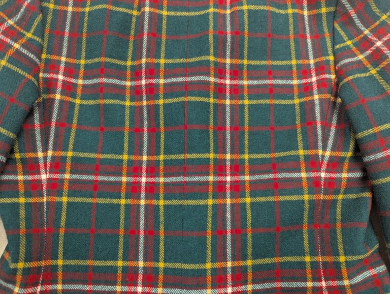 Detail of the back center seam of red and green plaid wool jacket made in 1971