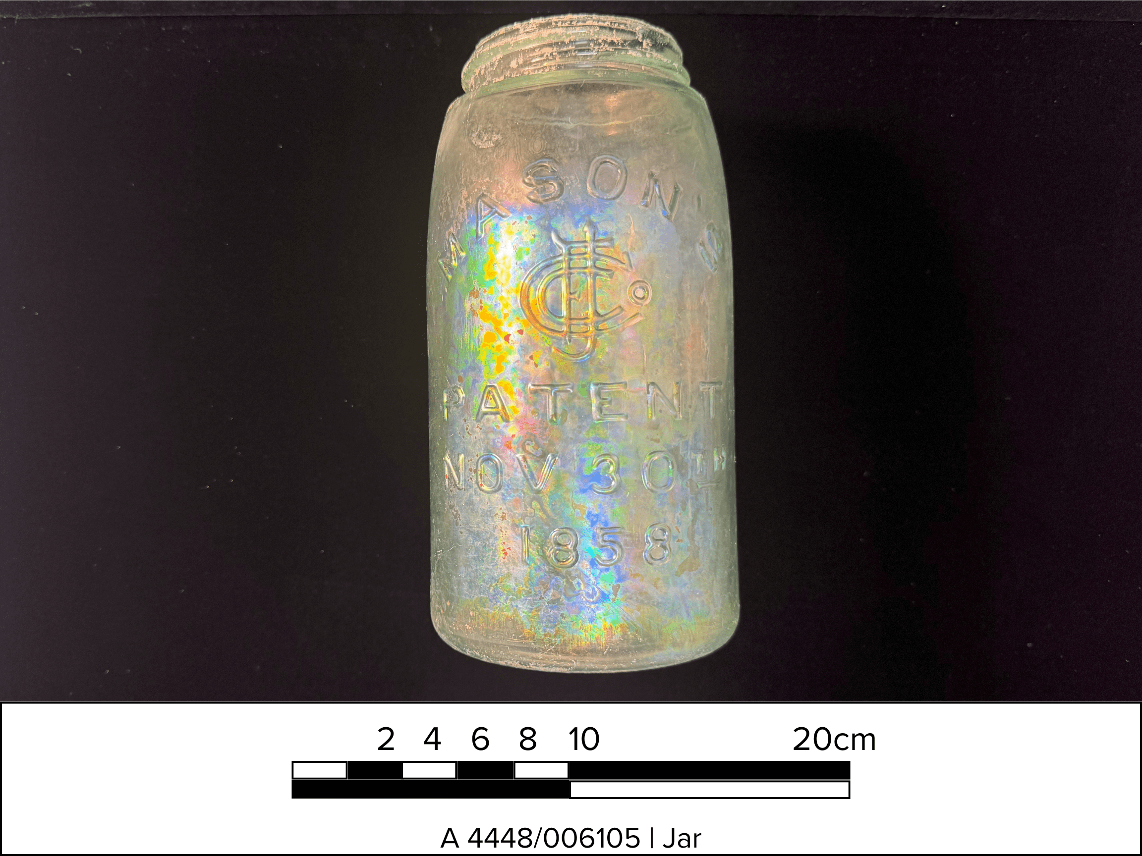 A greenish glass mason jar with text reading "Mason's Patent Nov 20th 1858." A scale bar and text on the bottom reads "A 4448/006105 | Jar"