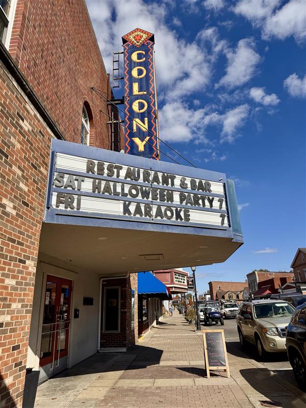 Picture of sign on building says Colony Restaurant & Bar
