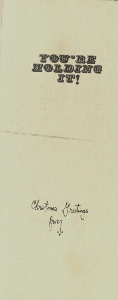 Black text on a tan paper background the text reads "You're holding it Christ Greetings from"