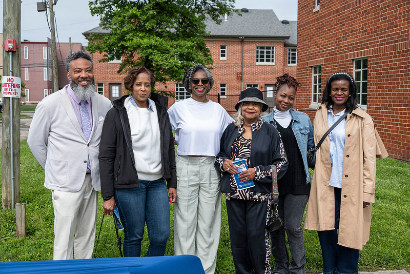 Guests smile for the camera before the start of the Poindexter Village African American Museum groundbreaking.