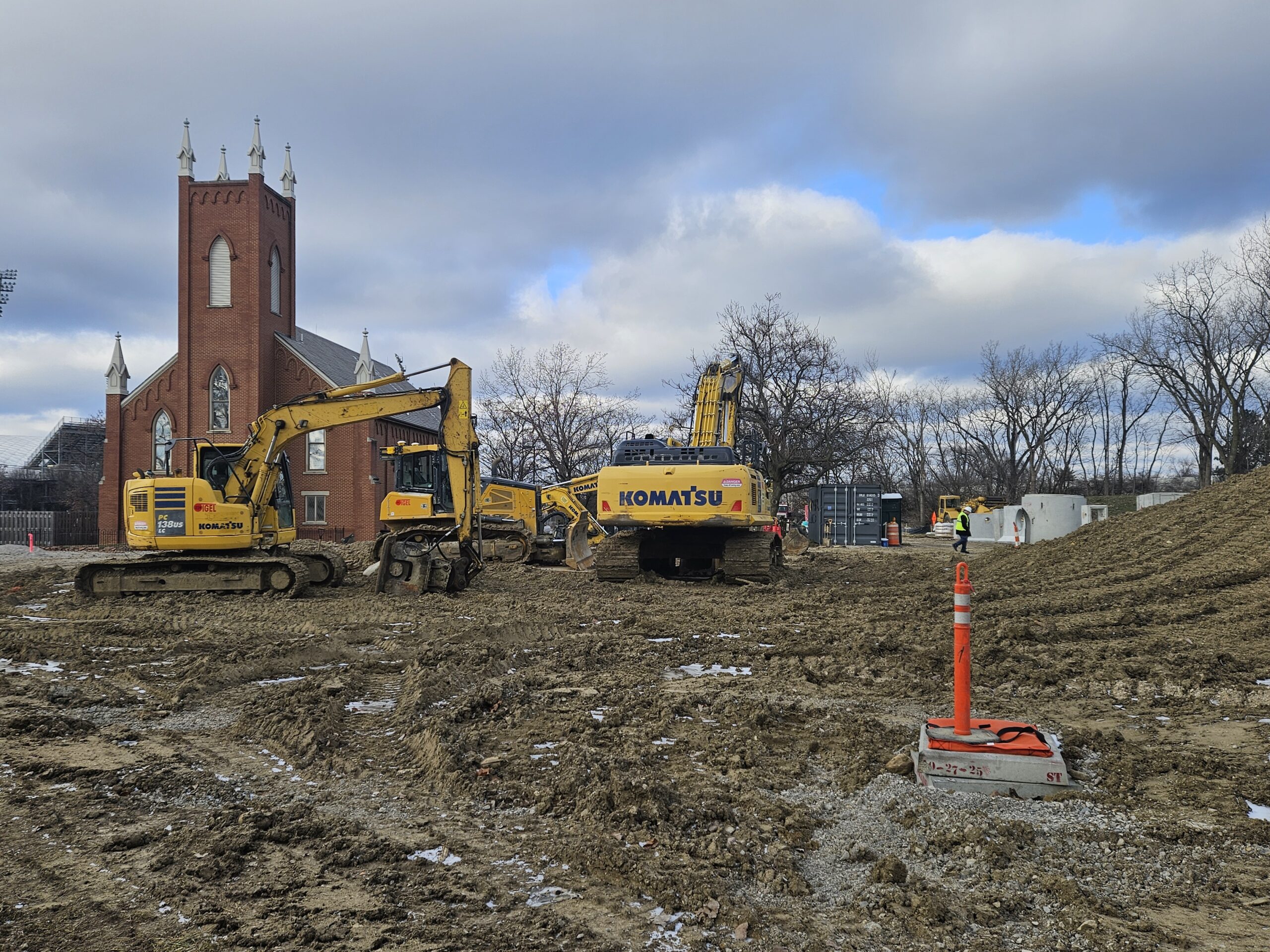 Construction equipment prepare to do work on the grounds in front of the Church at Ohio Village.