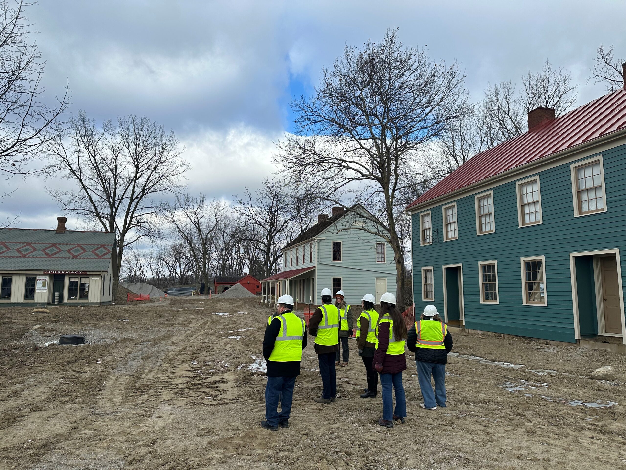 Crew in high-vis vest near the bike shop and toy store of Ohio Village.