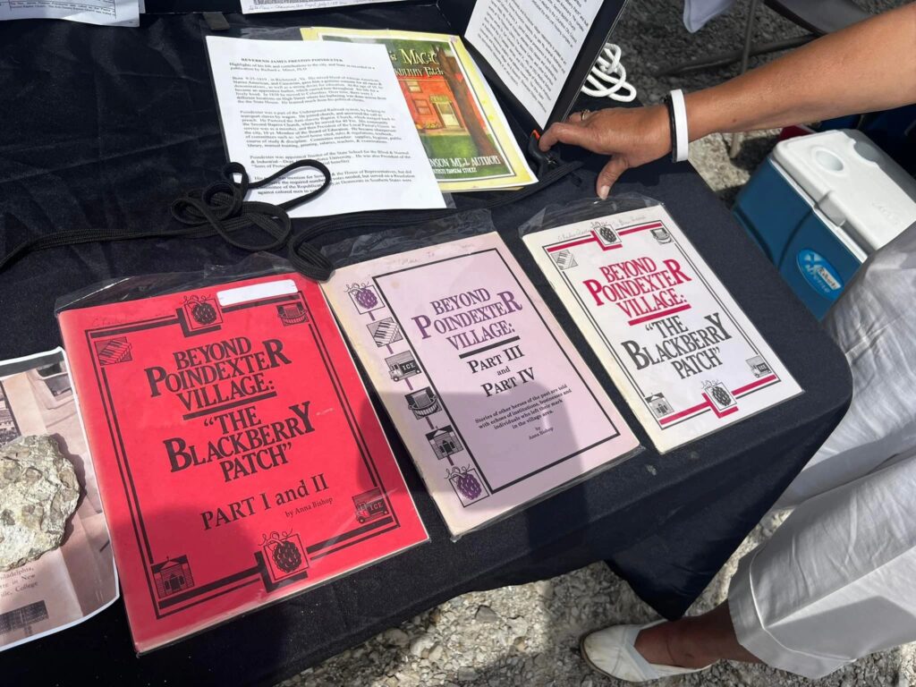 Books on a table, titles reading "Beyond Poindexter Village" Parts I and II, Parts III and IV.