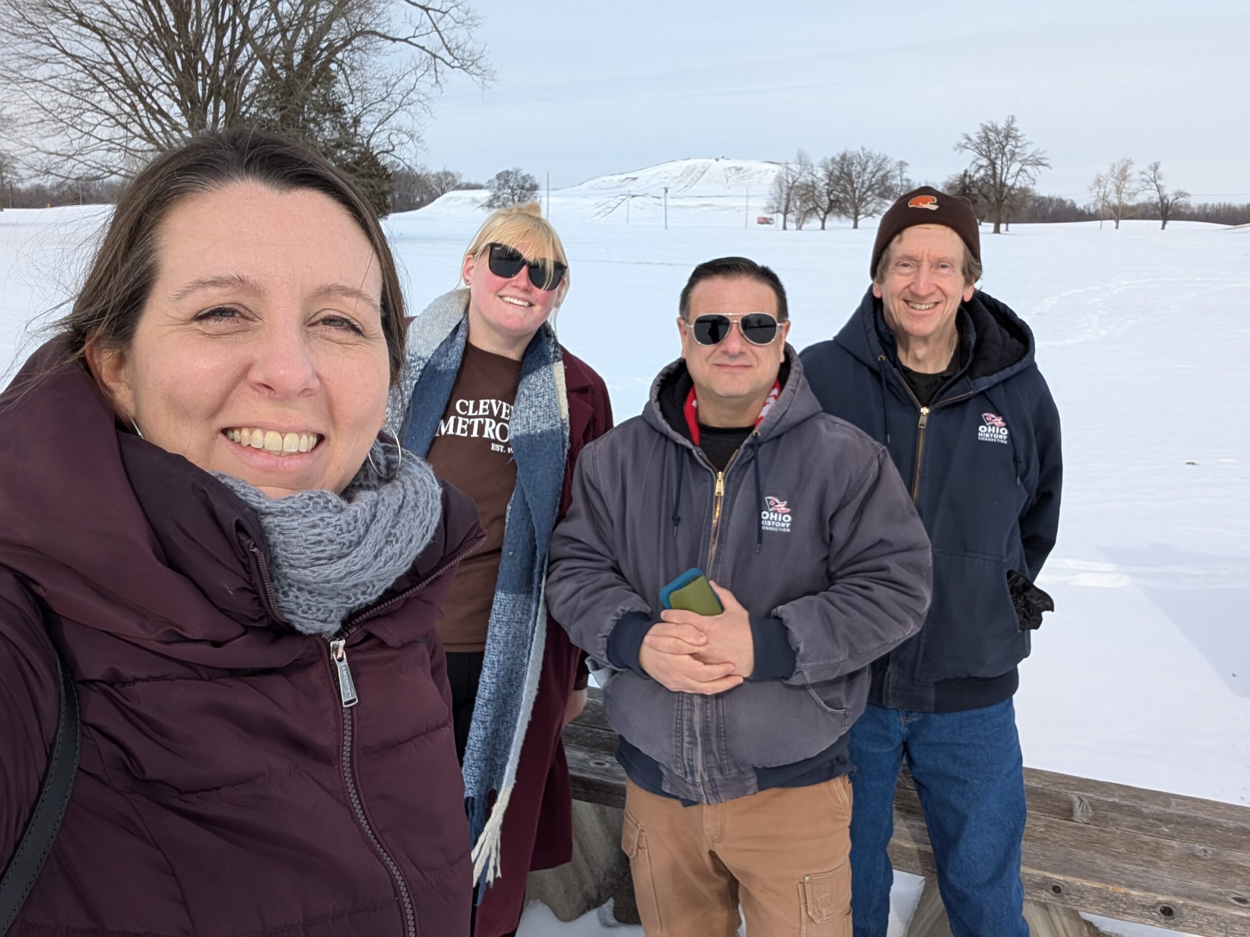 Jen Aultman, Sarah Hinkelman, Bill Kennedy, and Brad Lepper at the Cahokia Mounds State Historic Site in Illinois with Monk's Mound in the background.