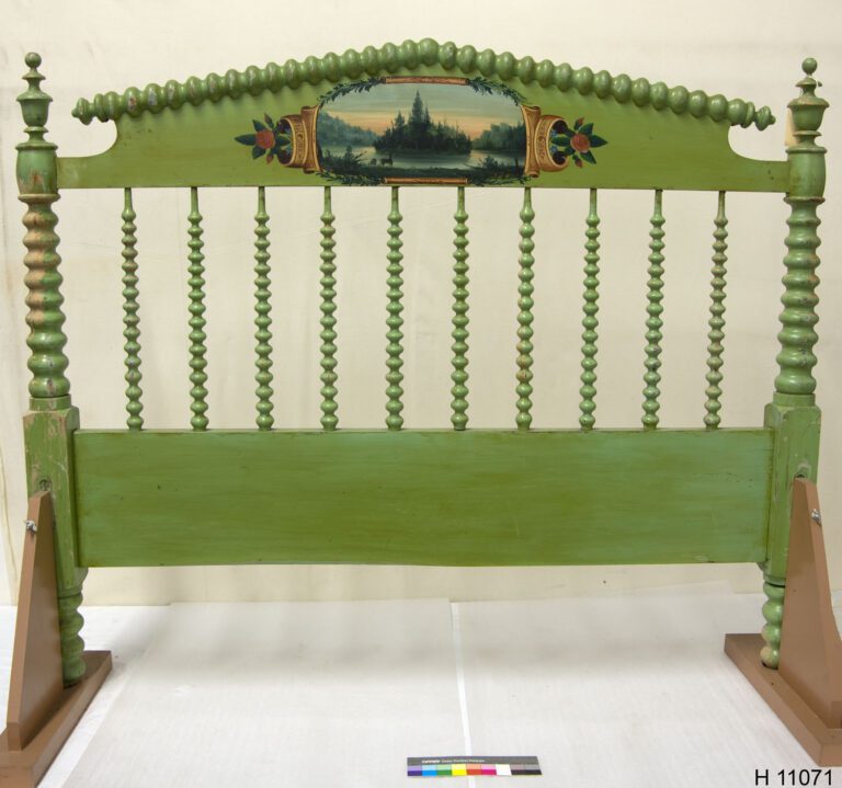 green painted footboard with tightly-turned posts and spindles and a painted romantic river scene on the center of the top rail