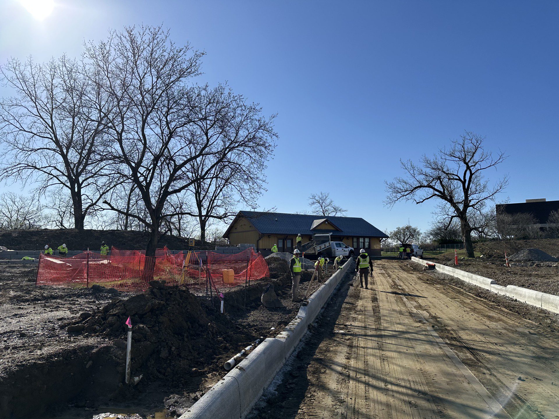 Streetscape curbs are placed by workers leading up to the entrance of Ohio Village.