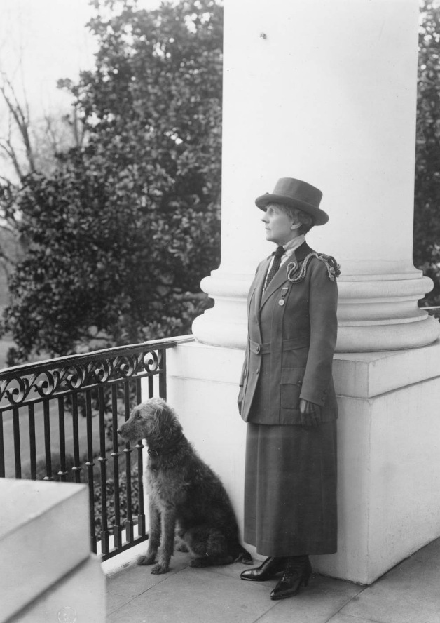 Florence Harding with the first family's dog, Laddie Boy, at the White House, Washington, D. C., ca. 1921-1923. Mrs. Harding is wearing the uniform of the Girl Scouts of the United States of America.