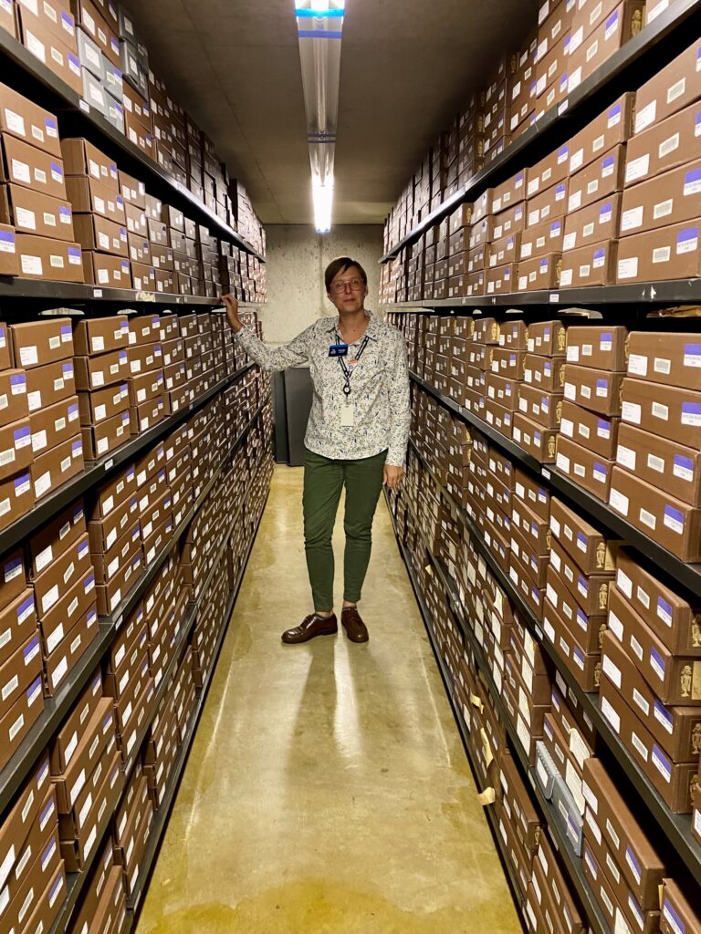 Archivist Wendy Korwin in the State Archives surrounded by boxes containing notes, letters and papers from the life of President Harding.