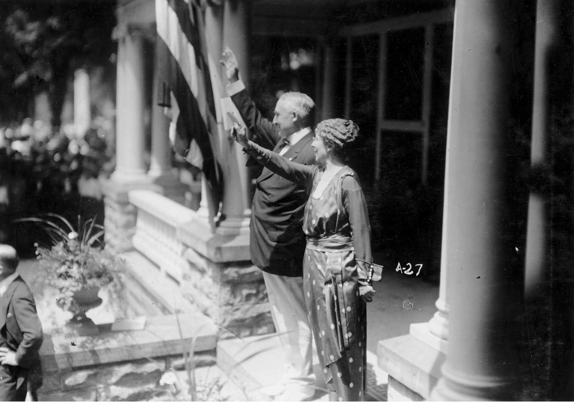 This image shows Warren and Florence Harding waving to a crowd of supporters.