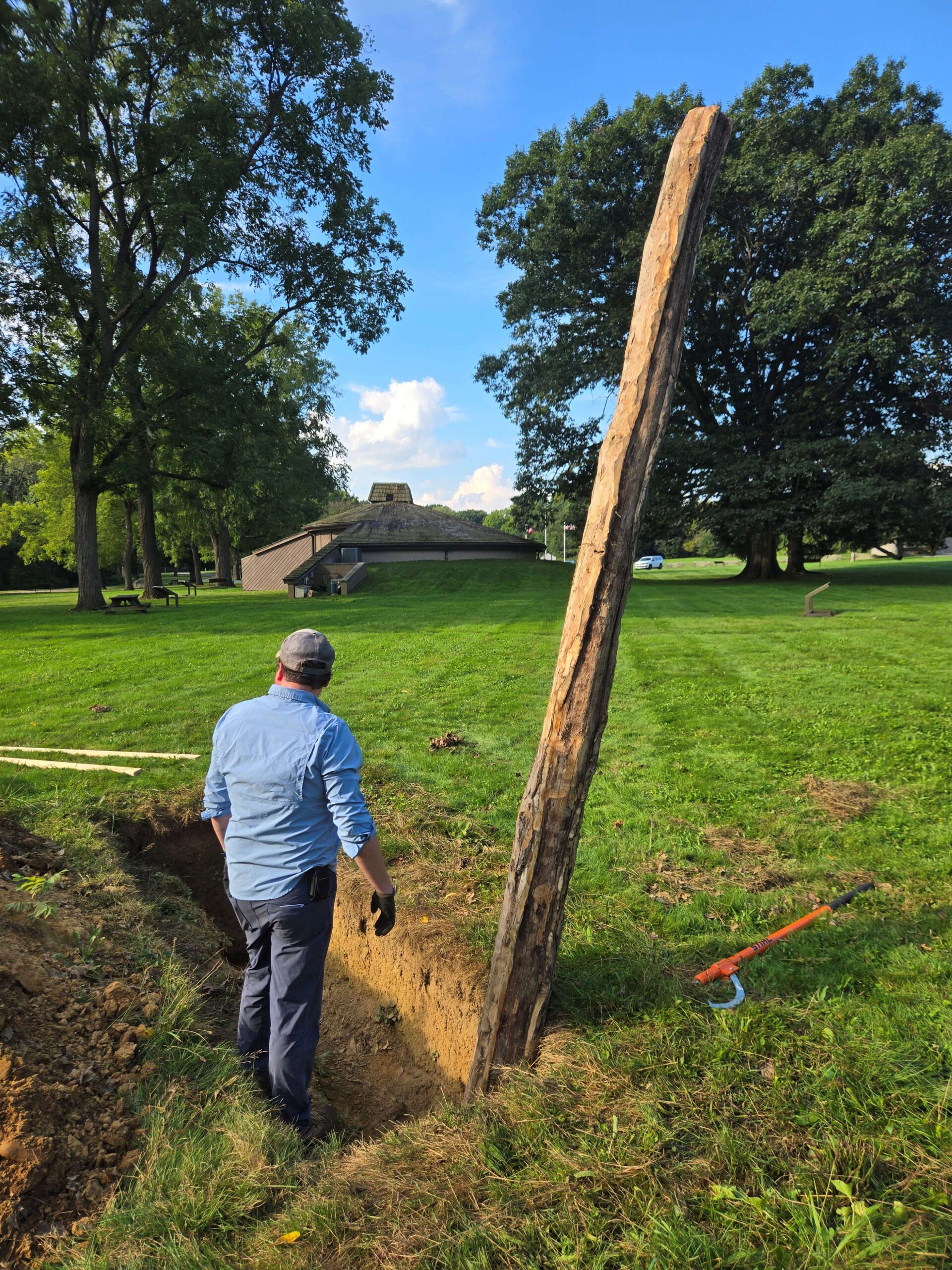 During the reconstruction of the Fort Laurens Palisade Wall in 2026, Peter Ellis, the Project crew chief, getting things ready to add the next timber.
