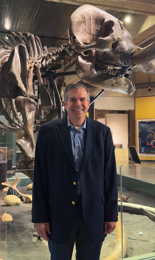 Brian Burdette, chief financial officer, stands in front of the Conway mastodon at the Ohio History Center.