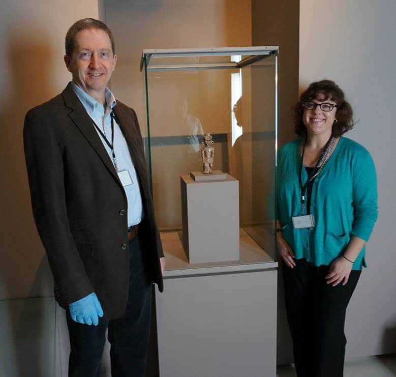 Curator of Archaeology Brad Lepper and Registrar of Collections Lesley Poling stand on either side of the case displaying the Adena Effigy Pipe.