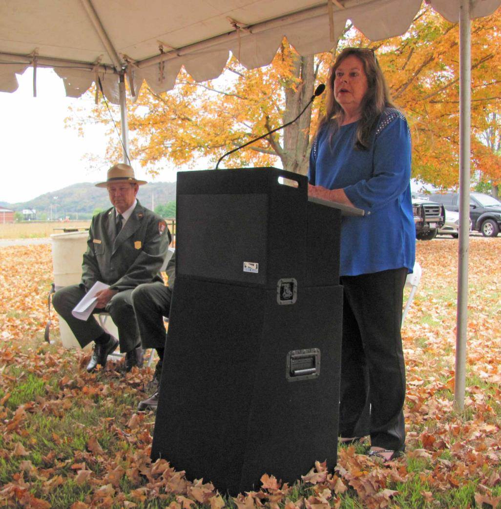 Chief Glenna Wallace of the Eastern Shawnee Tribe of Oklahoma delivers her remarks. Dean Alexander, superintendent of Hopewell Culture National Historical Park, is seated on the left.