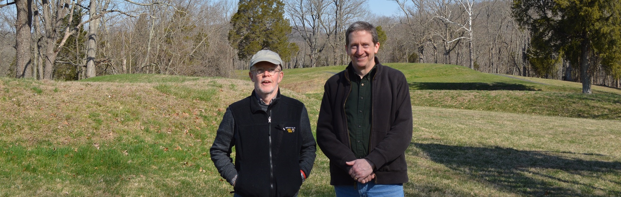 Noah Adams (left) and Brad Lepper standing in front of the Serpent Mound