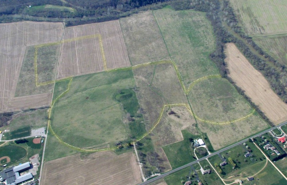 Aerial view of the Seip Earthworks. A transparent yellow line has been drawn over the photo to show the line of students.
